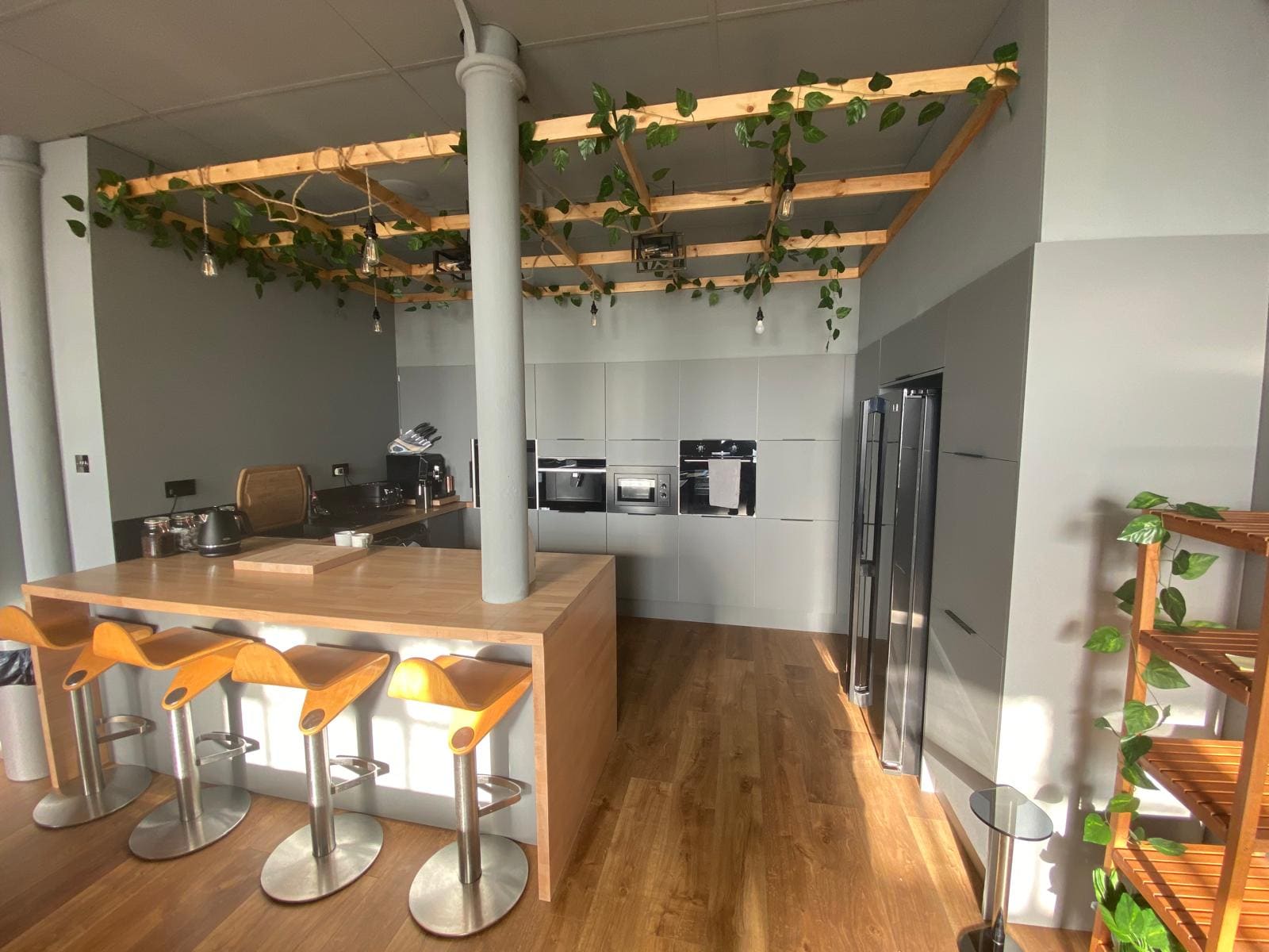 A fitted kitchen with timber canopy in daylight