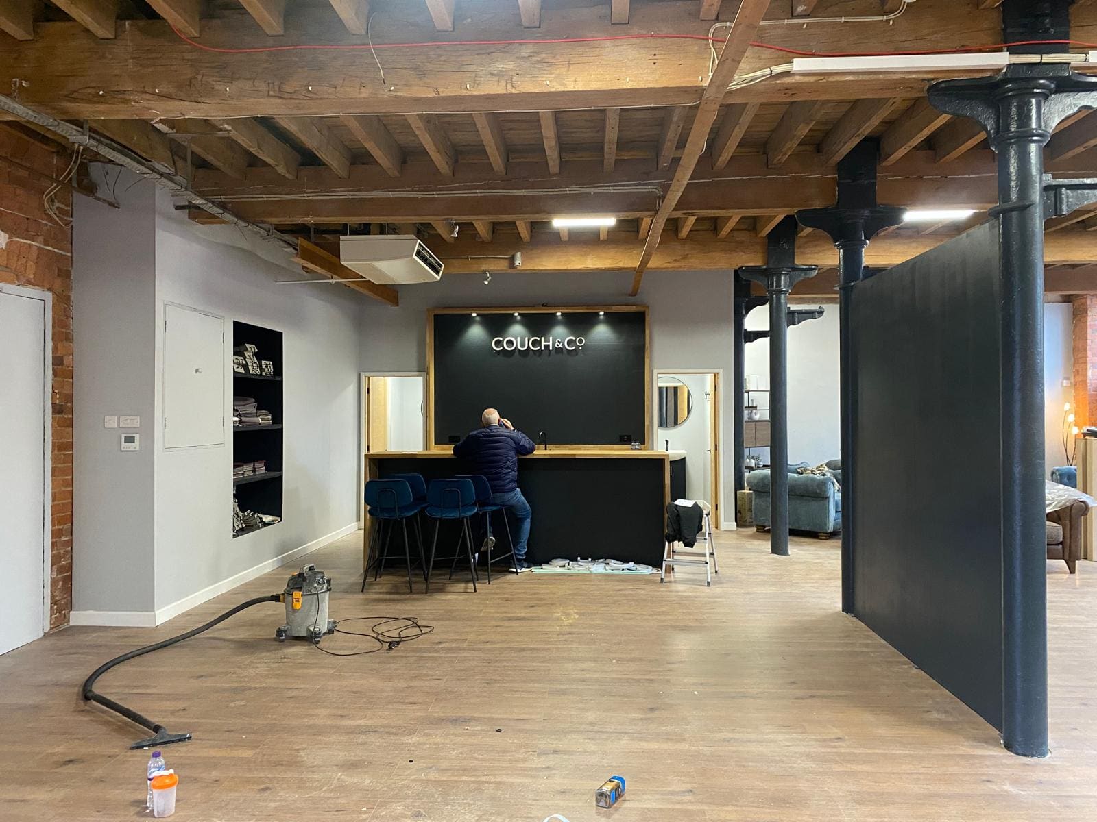 Furniture showroom reception with oak-topped counter